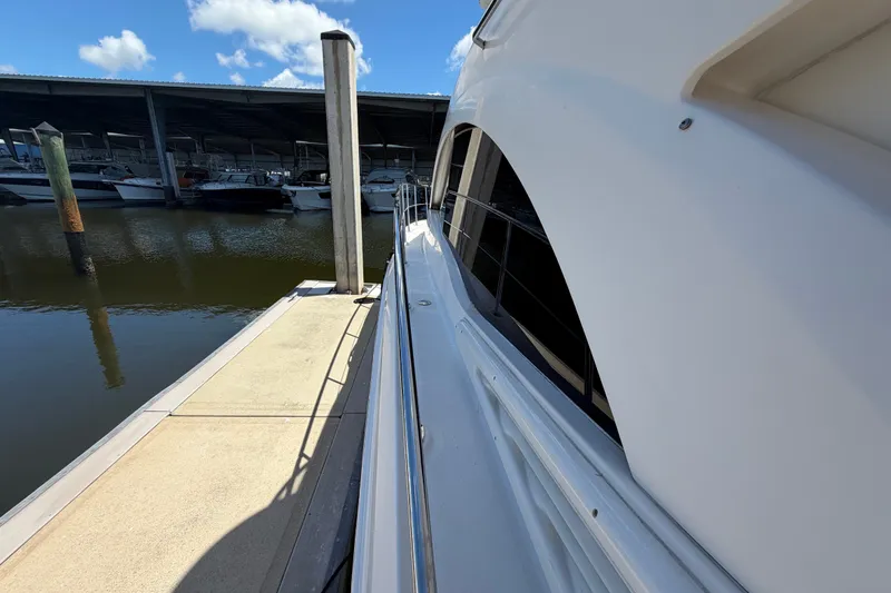 Slide: The Image of 2010 Sea Ray 390 Sedan Bridge docked at marina under clear blue sky. - 10