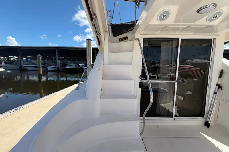 Slide: The Image of 2010 Sea Ray 390 Sedan Bridge yacht with stairs and marina view. - 28