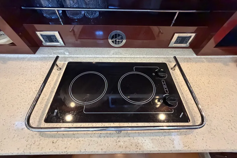 Slide: The Image of Stovetop in 2010 Sea Ray 390 Sedan Bridge yacht kitchen, featuring sleek design and modern controls. - 71