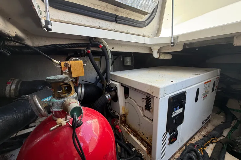 Slide: The Image of Engine room of 2010 Sea Ray 390 Sedan Bridge with generator and fire extinguisher. - 147