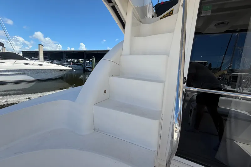 Slide: The Image of Stairs on a 2010 Sea Ray 390 Sedan Bridge yacht, docked at a marina. - 27