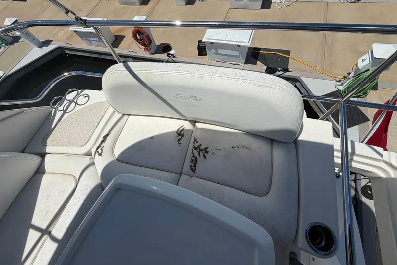 Slide: The Image of 2010 Sea Ray 390 Sedan Bridge boat seating area with visible wear and stains. - 33
