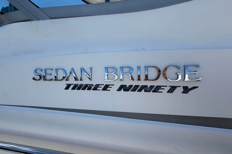 Slide: The Image of 2010 Sea Ray 390 Sedan Bridge boat nameplate with chrome lettering. - 150