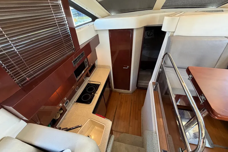 Slide: The Image of Interior of 2010 Sea Ray 390 Sedan Bridge yacht with modern kitchen and dining area. - 61