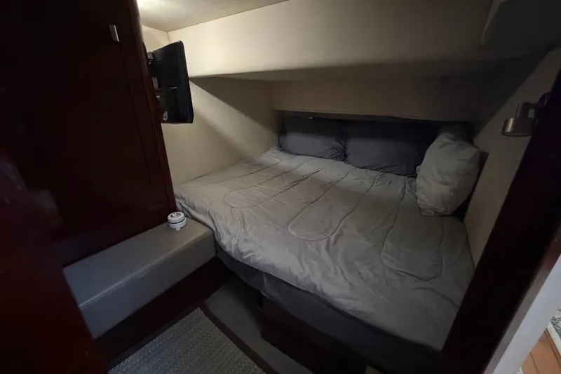 Slide: The Image of Cozy bedroom in 2010 Sea Ray 390 Sedan Bridge yacht with TV and comfortable bedding. - 124