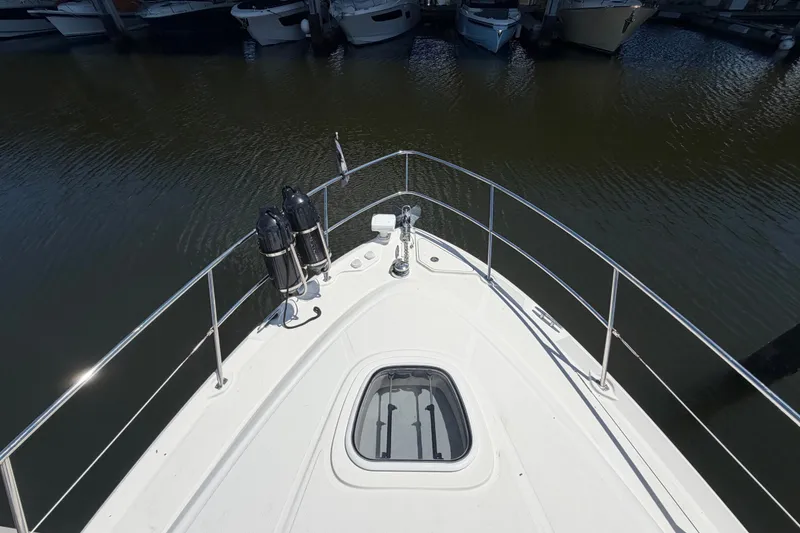 Slide: The Image of Bow view of 2010 Sea Ray 390 Sedan Bridge yacht docked at marina. - 6