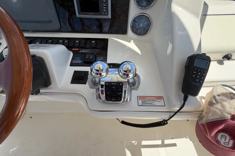 Slide: The Image of Control panel of a 2010 Sea Ray 390 Sedan Bridge with steering wheel and communication device. - 42