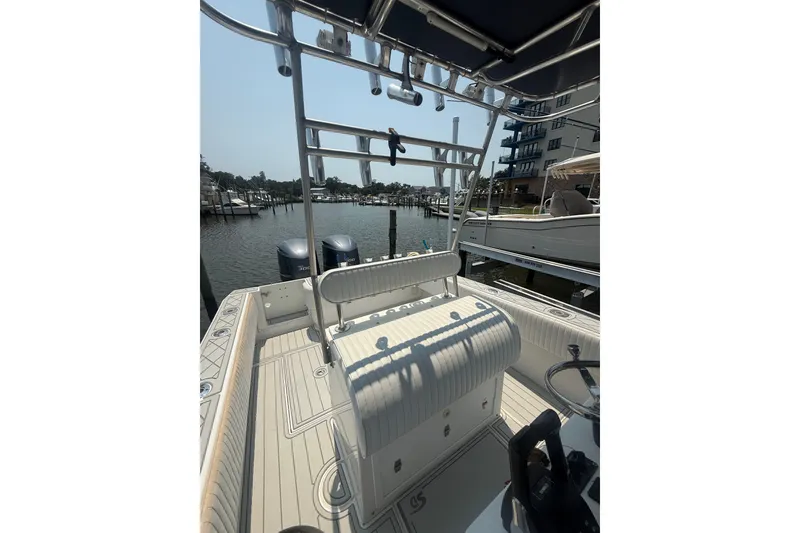 Slide: The Image of 2006 Contender 27 Open boat interior with dual engines docked at marina. - 5