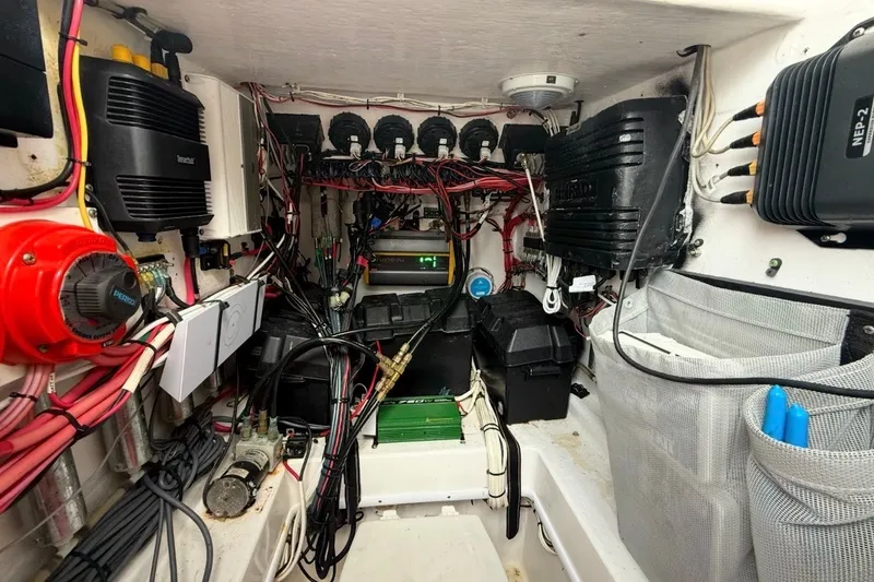 Slide: The Image of Electrical system inside a 2006 Contender 27 Open boat, showcasing wiring and components. - 12