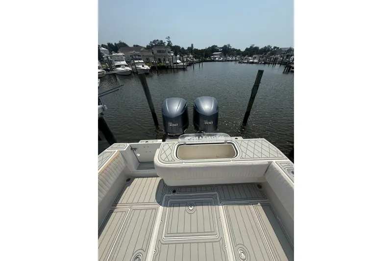 Slide: The Image of 2006 Contender 27 Open boat with twin engines docked in a marina. - 7