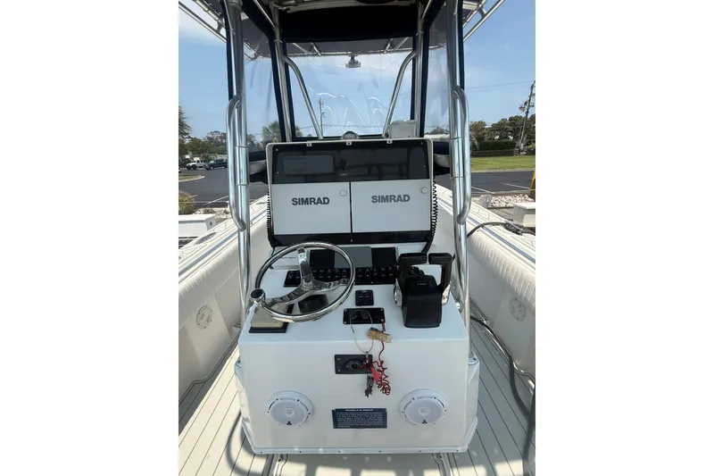 Slide: The Image of 2006 Contender 27 Open boat console with Simrad electronics and steering wheel. - 4