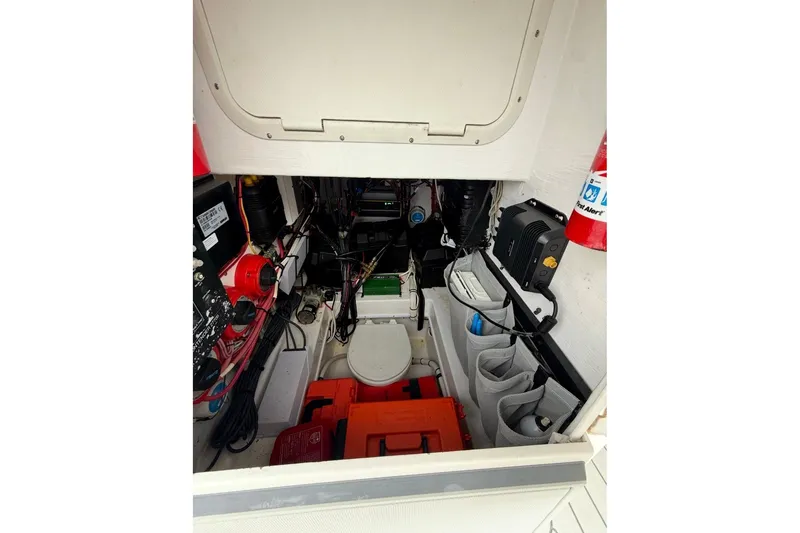 Slide: The Image of 2006 Contender 27 Open boat interior with equipment and storage compartments. - 10