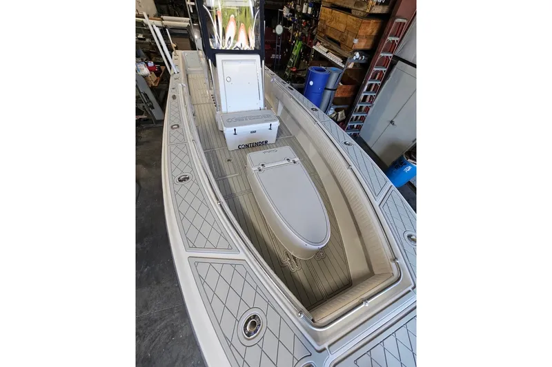 Slide: The Image of 2006 Contender 27 Open boat interior with storage compartments and sleek design. - 15