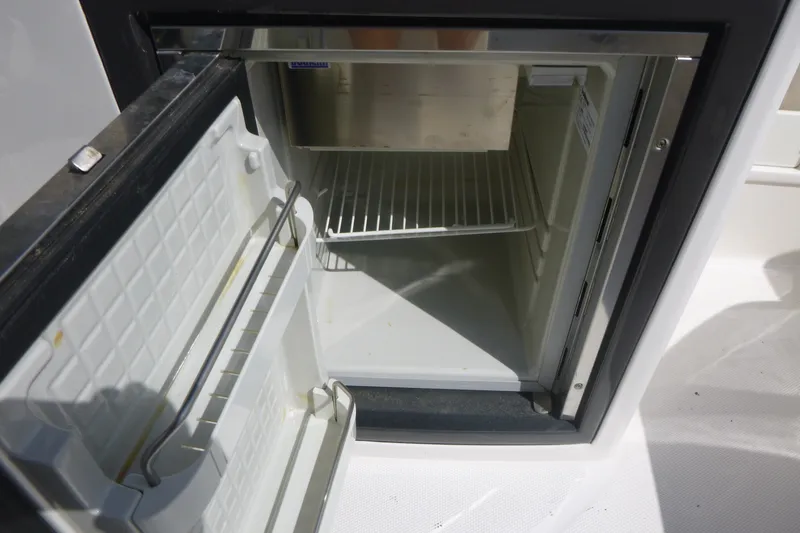 Slide: The Image of Open refrigerator on a 2014 Monterey 288SS Super Sport boat. - 18