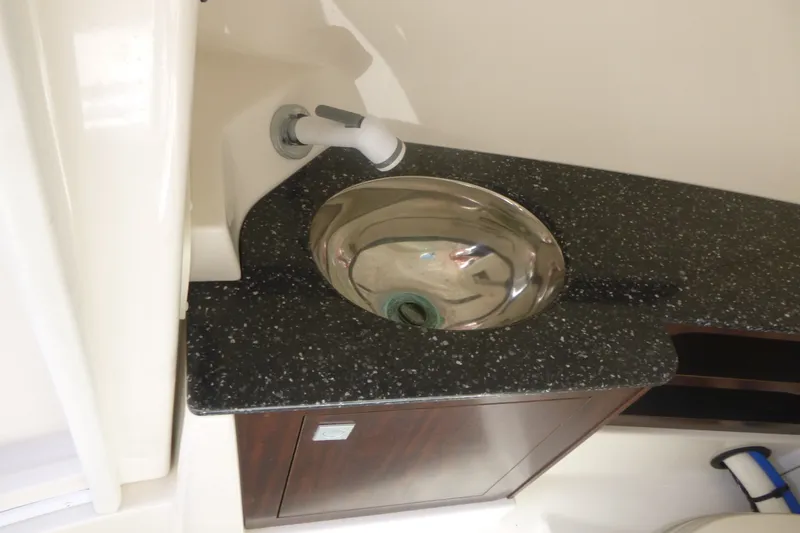Slide: The Image of Stainless steel sink on 2014 Monterey 288SS Super Sport boat with speckled countertop. - 14