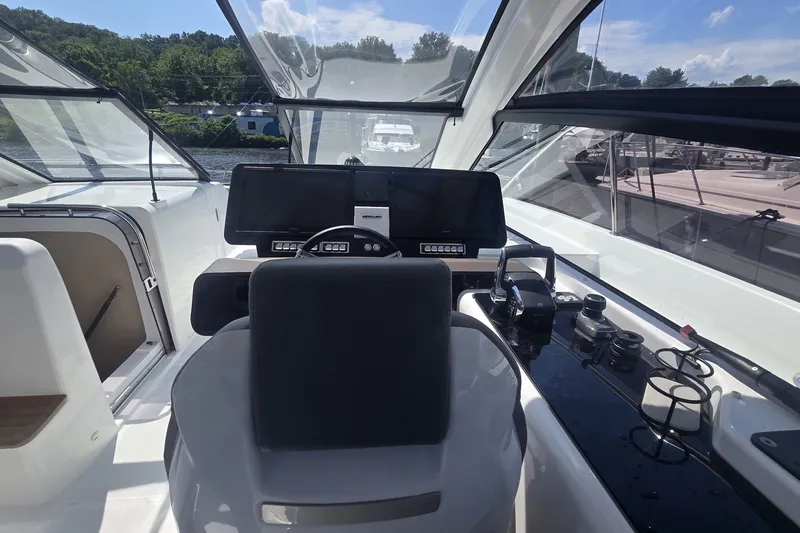Slide: The Image of 2025 Four Winns TH36 yacht cockpit with modern controls and panoramic windows. - 12