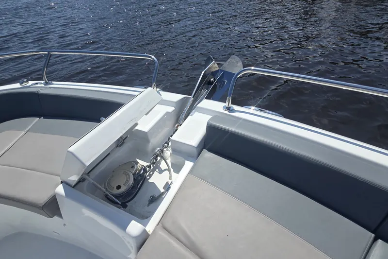 Slide: The Image of Bow seating area of 2025 Four Winns TH36 boat with anchor compartment. - 17