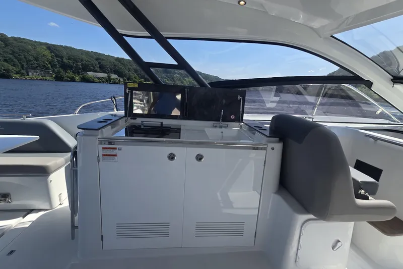 Slide: The Image of 2025 Four Winns TH36 yacht interior with sleek kitchen area and scenic water view. - 9