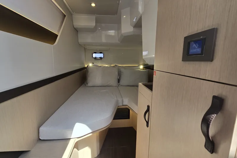 Slide: The Image of 2025 Four Winns TH36 cabin interior with modern design and cozy sleeping area. - 24