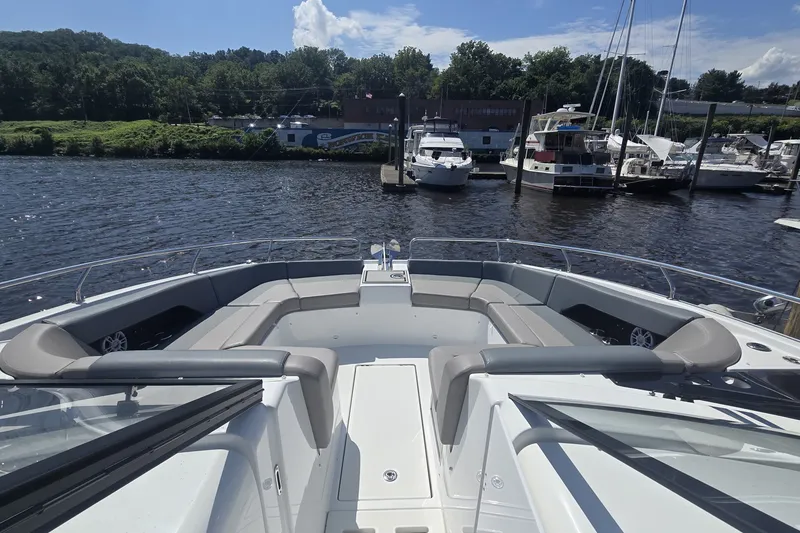 Slide: The Image of 2025 Four Winns TH36 boat docked at marina, featuring spacious seating and scenic waterfront view. - 15