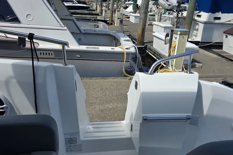 Slide: The Image of 2025 Four Winns TH36 yacht docked at marina, showcasing sleek design and modern features. - 8