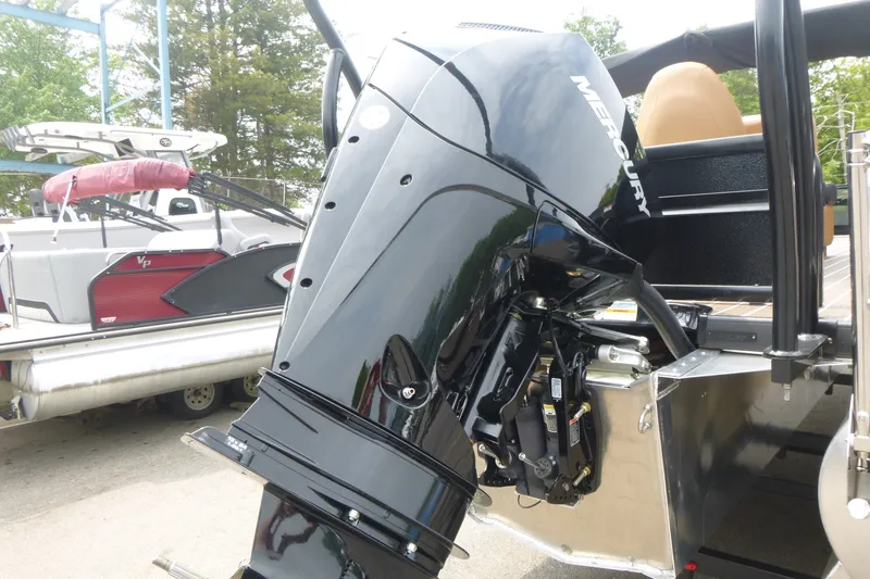 Slide: The Image of Premier 230 Sunsation RS - CL 2027 with Mercury outboard motor, docked beside another boat. - 18