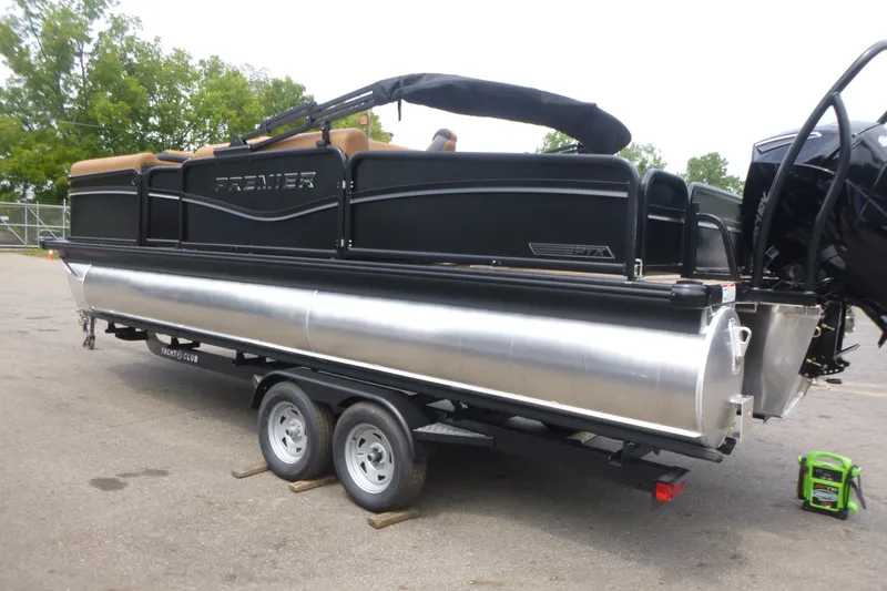 Slide: The Image of 2027 Premier 230 Sunsation RS - CL pontoon boat on trailer, parked outdoors. - 4