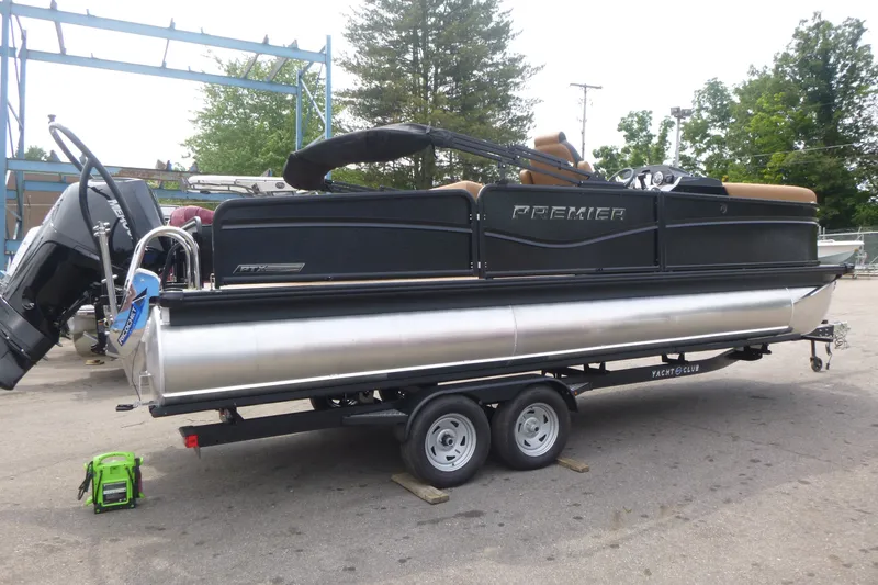 The Image of 2027 Premier 230 Sunsation RS - CL pontoon boat on trailer, parked outdoors. - 1