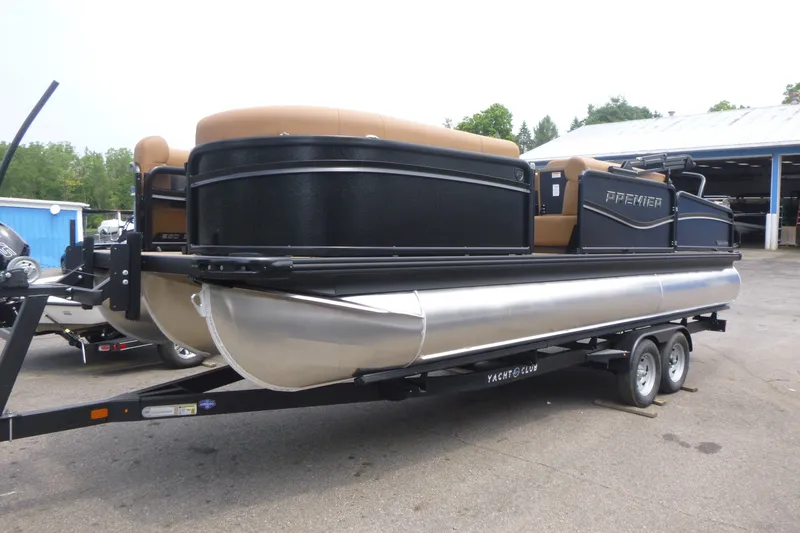 Slide: The Image of 2027 Premier 230 Sunsation RS - CL pontoon boat on trailer, parked outdoors. - 3