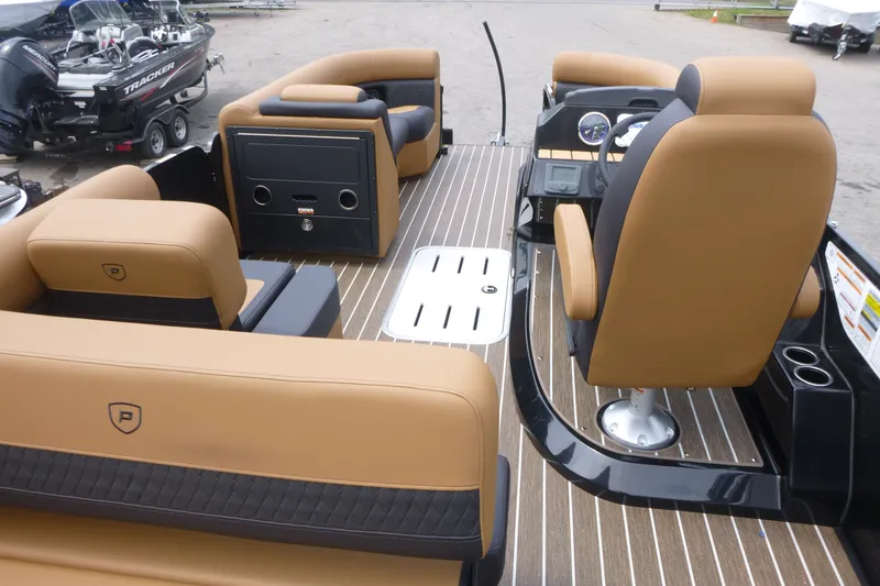 Slide: The Image of 2027 Premier 230 Sunsation RS - CL pontoon boat interior with tan seating and modern dashboard. - 7