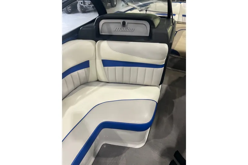 Slide: The Image of Interior seating of 2015 Malibu Wakesetter 24 MXZ with white and blue upholstery. - 13