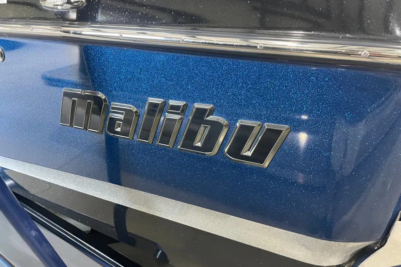 Slide: The Image of 2015 Malibu Wakesetter 24 MXZ boat with metallic blue finish and logo. - 4