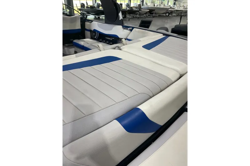 Slide: The Image of 2015 Malibu Wakesetter 24 MXZ interior with white and blue seating. - 9