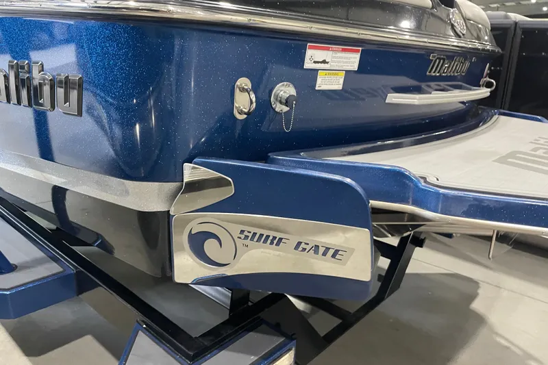 Slide: The Image of 2015 Malibu Wakesetter 24 MXZ boat with Surf Gate feature, blue exterior. - 3