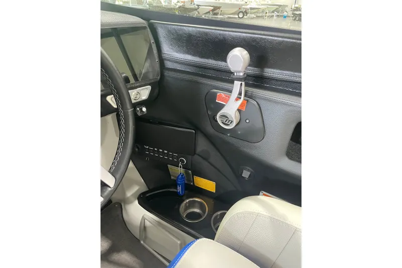 Slide: The Image of 2015 Malibu Wakesetter 24 MXZ dashboard with steering wheel and control panel. - 17