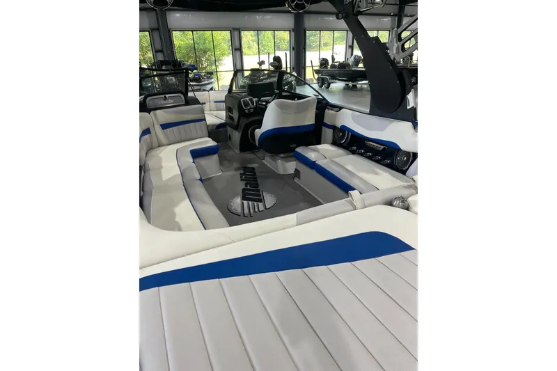 Slide: The Image of 2015 Malibu Wakesetter 24 MXZ interior with white and blue seating, spacious layout. - 10