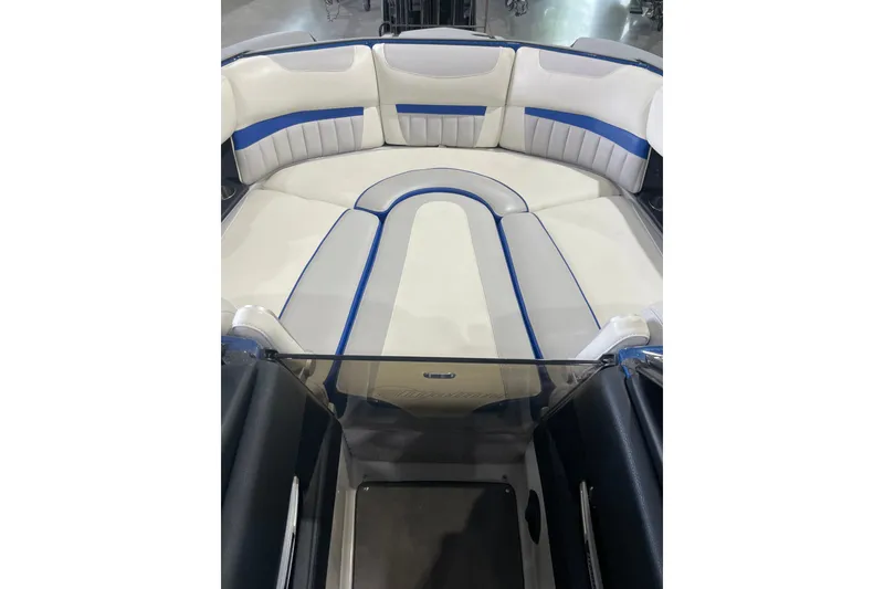 Slide: The Image of 2015 Malibu Wakesetter 24 MXZ boat interior with white and blue seating. - 12