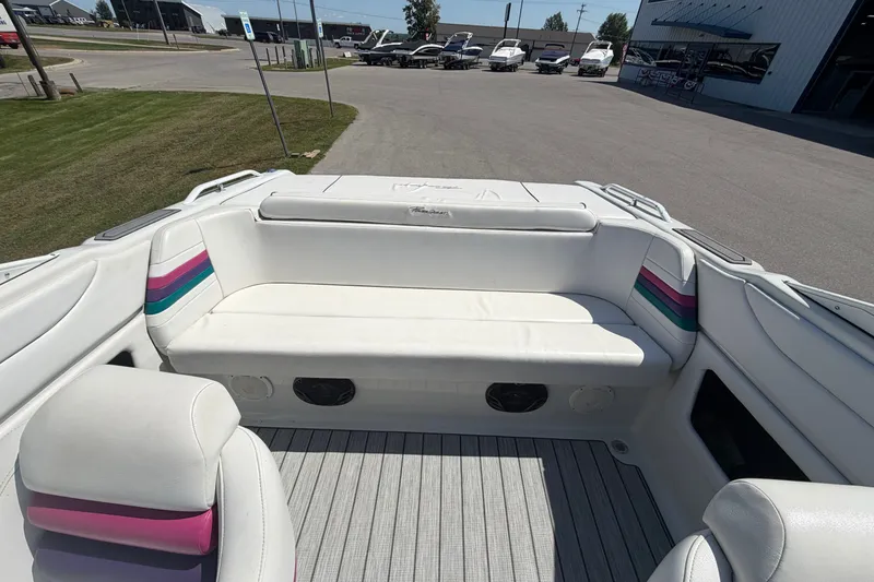 Slide: The Image of 1995 Powerquest 257 Legend boat interior with white seating and colorful accents. - 10