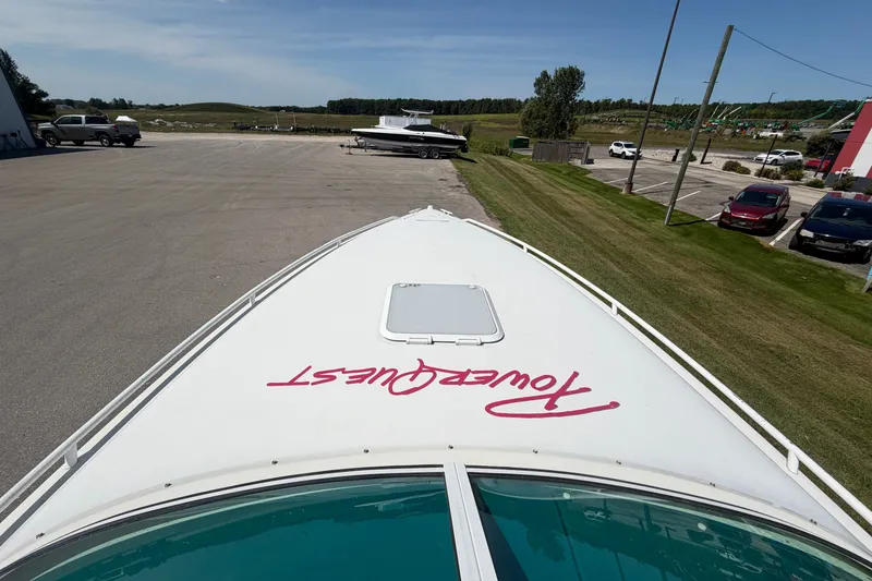 Slide: The Image of 1995 Powerquest 257 Legend boat parked on a sunny day near a grassy area. - 17