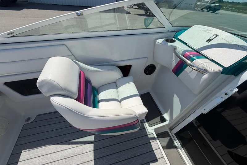 Slide: The Image of Interior of a 1995 Powerquest 257 Legend boat with colorful seating and dashboard. - 11