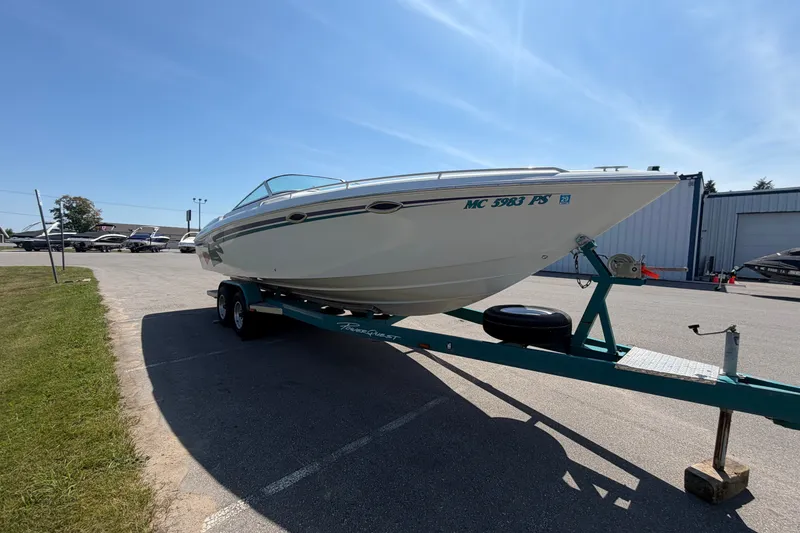 Slide: The Image of 1995 Powerquest 257 Legend boat on trailer in parking lot under clear sky. - 6