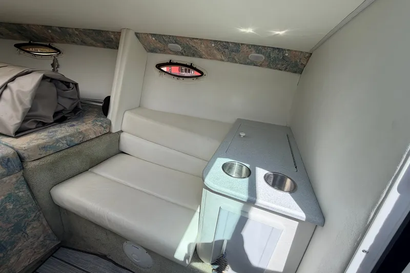 Slide: The Image of Interior of a 1995 Powerquest 257 Legend boat with seating and cup holders. - 15