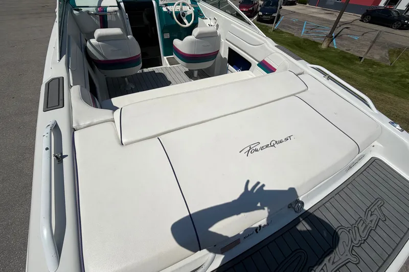 Slide: The Image of 1995 Powerquest 257 Legend boat interior with white seating and logo. - 8