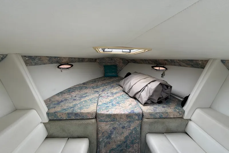 Slide: The Image of Interior cabin of a 1995 Powerquest 257 Legend boat with cushioned seating. - 14