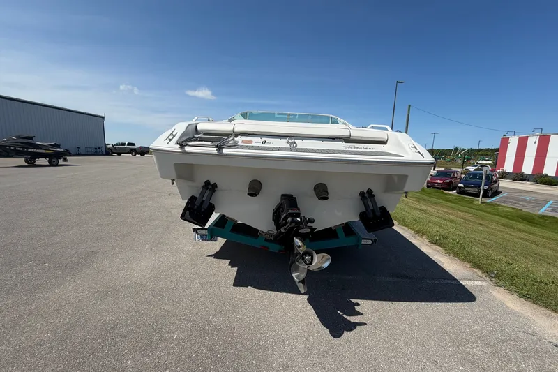Slide: The Image of 1995 Powerquest 257 Legend boat on trailer, rear view, parked outdoors. - 3