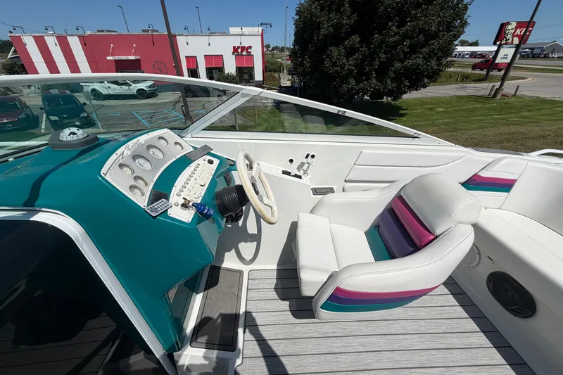 Slide: The Image of 1995 Powerquest 257 Legend boat interior with colorful seating and control panel. - 12