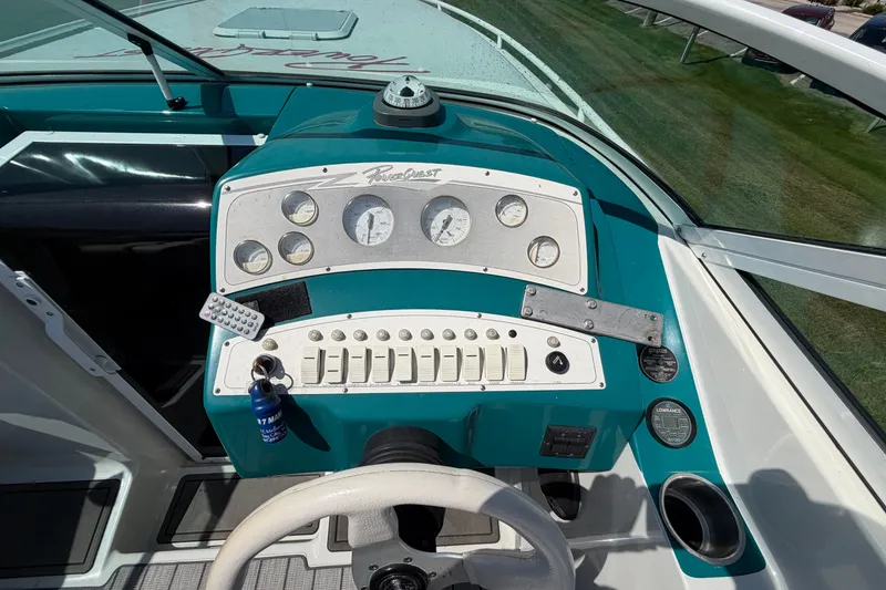 Slide: The Image of Dashboard of a 1995 Powerquest 257 Legend boat with gauges and controls. - 13