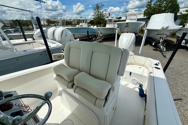 Slide: The Image of 2023 Sea Hunt Ultra 239SE boat interior with dual seats and steering wheel. - 13