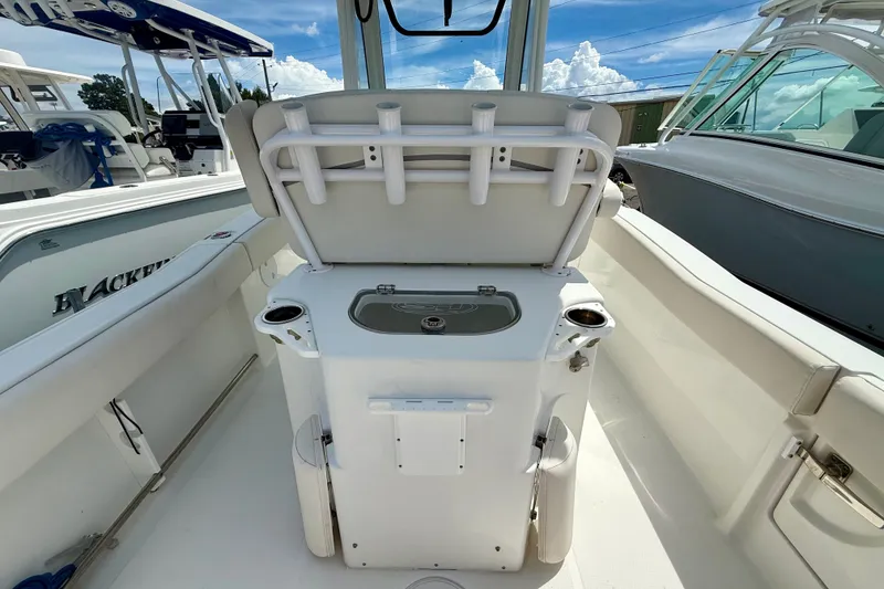Slide: The Image of 2023 Sea Hunt Ultra 239SE boat interior with rod holders and seating. - 9