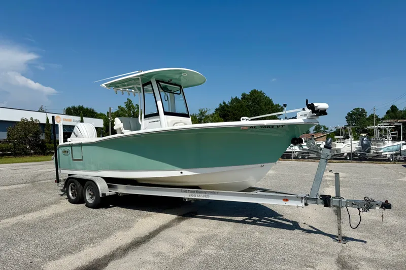 The Image of 2023 Sea Hunt Ultra 239SE boat on trailer in sunny outdoor setting. - 0